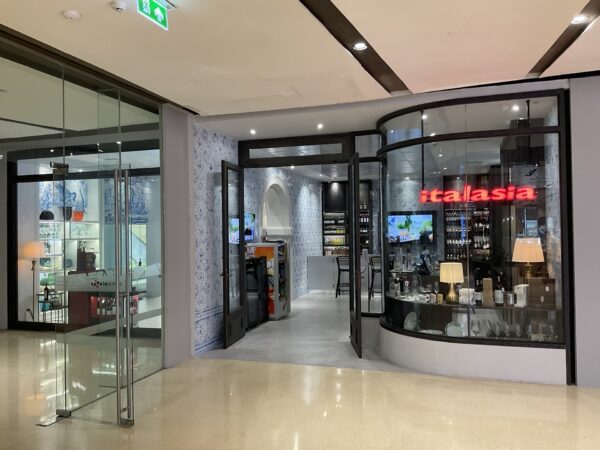 A renovated Italia wine cellar featuring glass doors and a glass counter at the front entrance, inviting customers inside