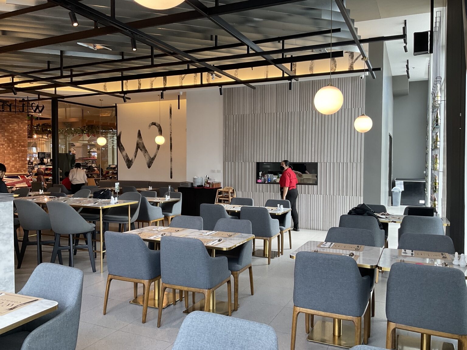 Interior view of the renovated 'Wine Connection' restaurant, showcasing stylish tables and chairs for dining