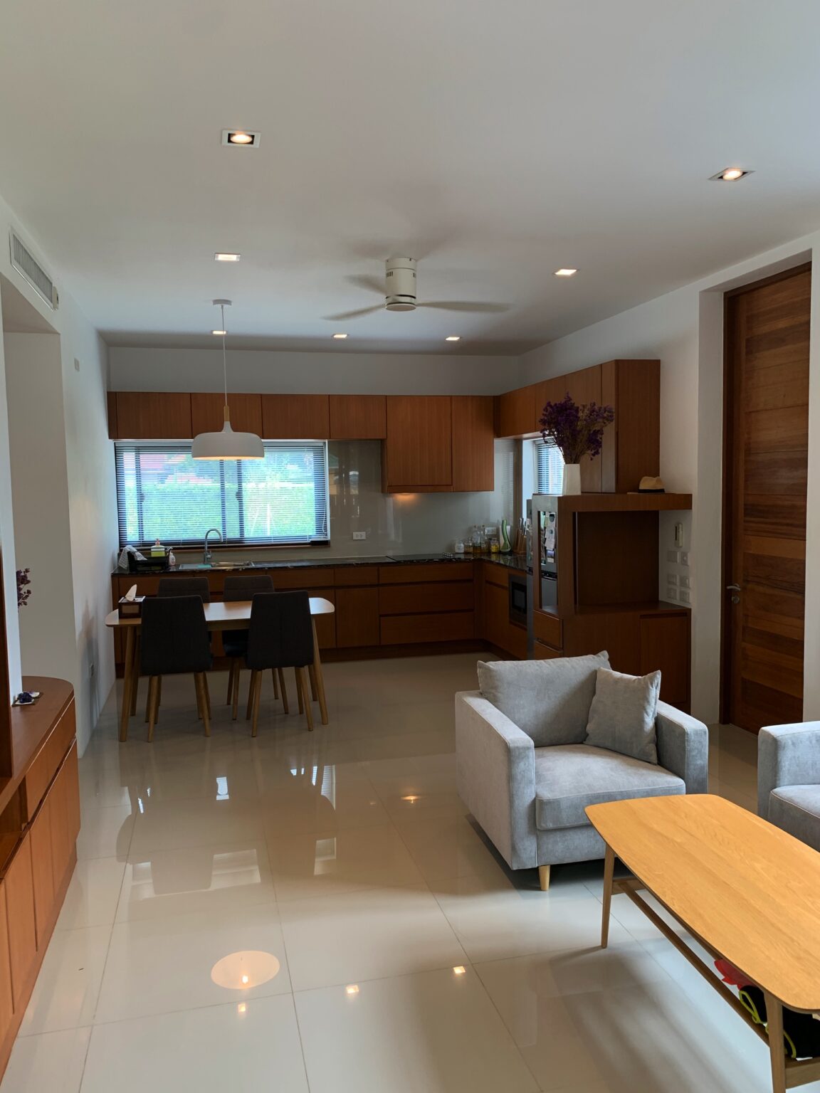 Modern kitchen and living room area in the 'Eden Thai' villa, featuring sleek furnishings and a harmonious layout.