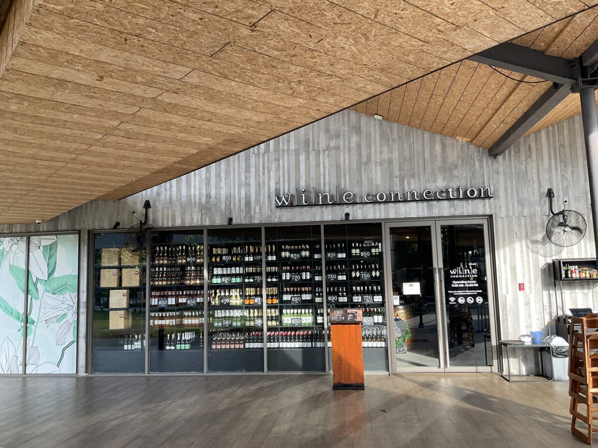 Outisde view of a renovated wine connection restaurant, showcasing shelves filled with various products and inviting ambiance.