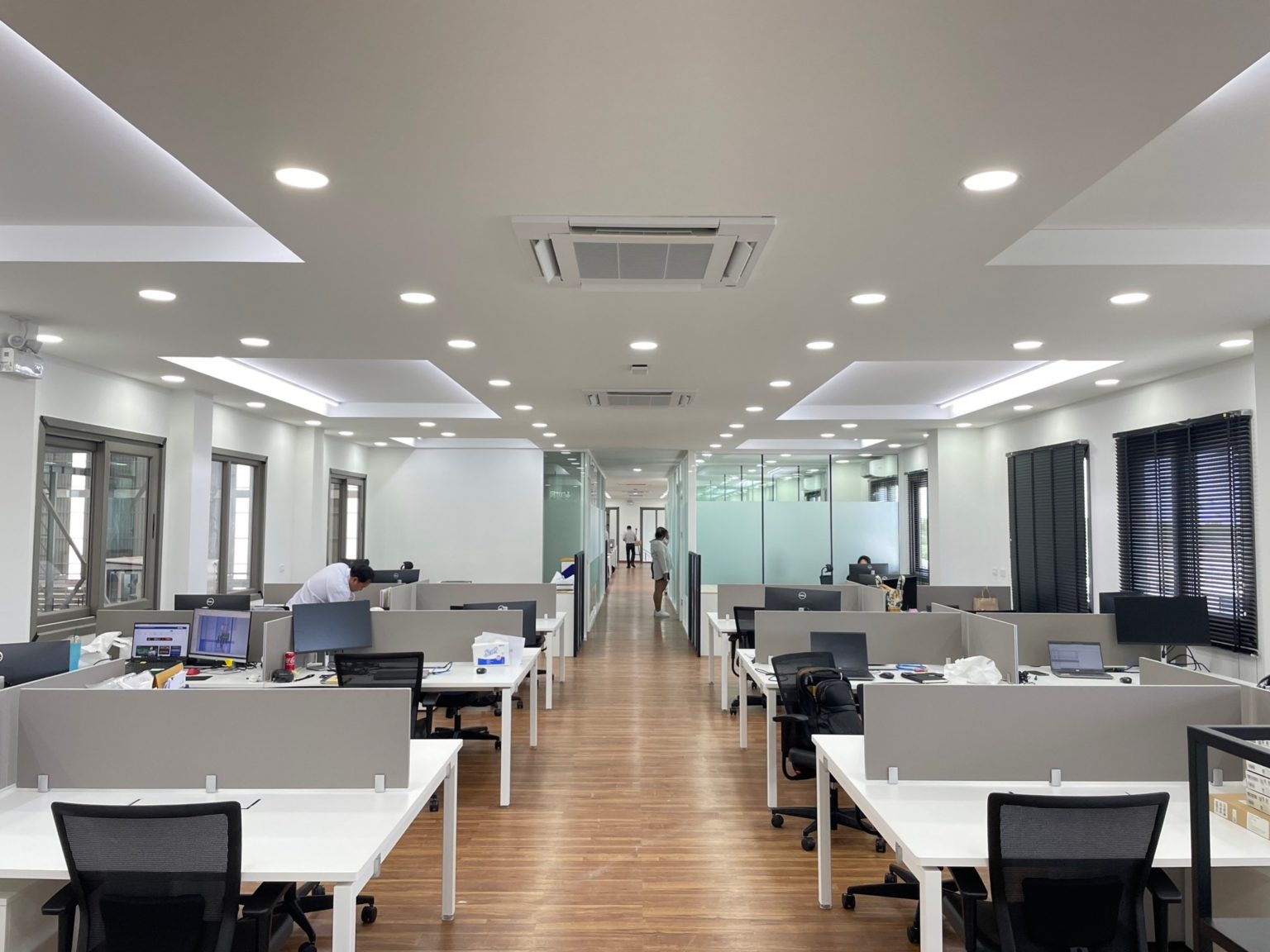 A modern, renovated office featuring multiple desks equipped with computers, promoting a productive work environment.