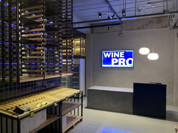 Chic wine retail shop design highlighting a renovated space with sophisticated shelving and an inviting ambiance.