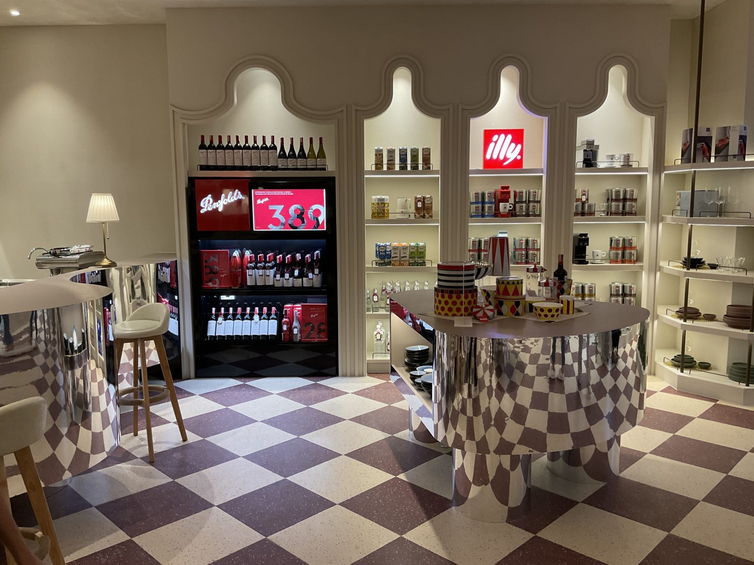 A renovated Italian wine showroom featuring a stylish bar and a counter adorned with an array of drinks.