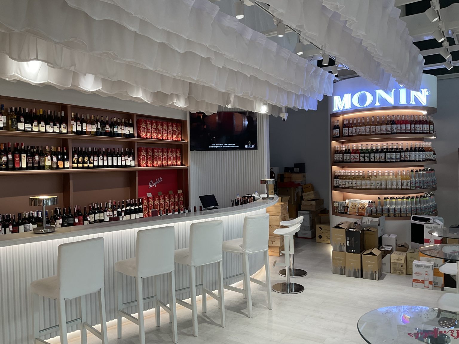 A stylish bar in a renovated Italian wine showroom, offering a wide selection of drinks and delectable food choices.