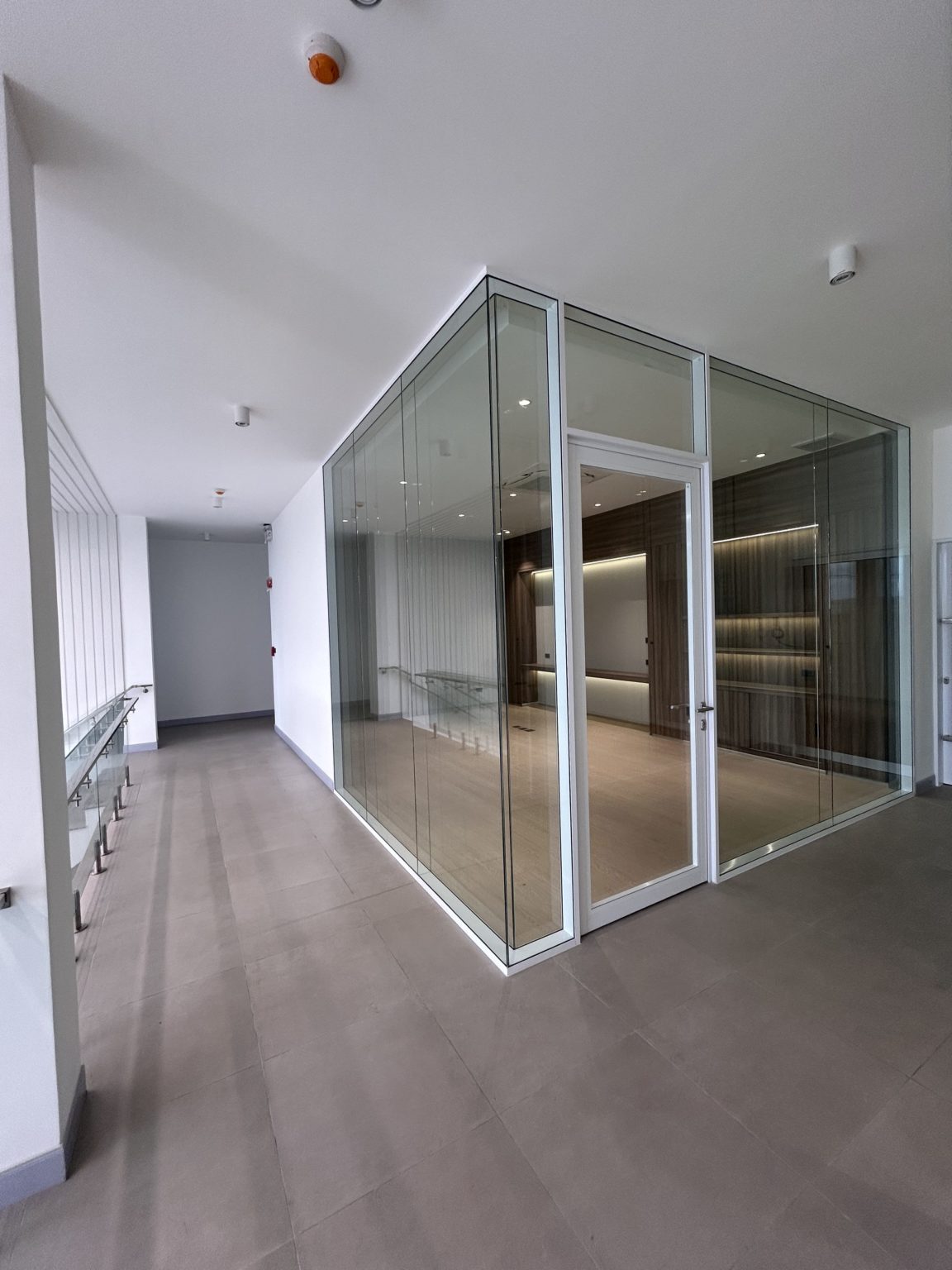 Office with glass wallas seen from the hallway.