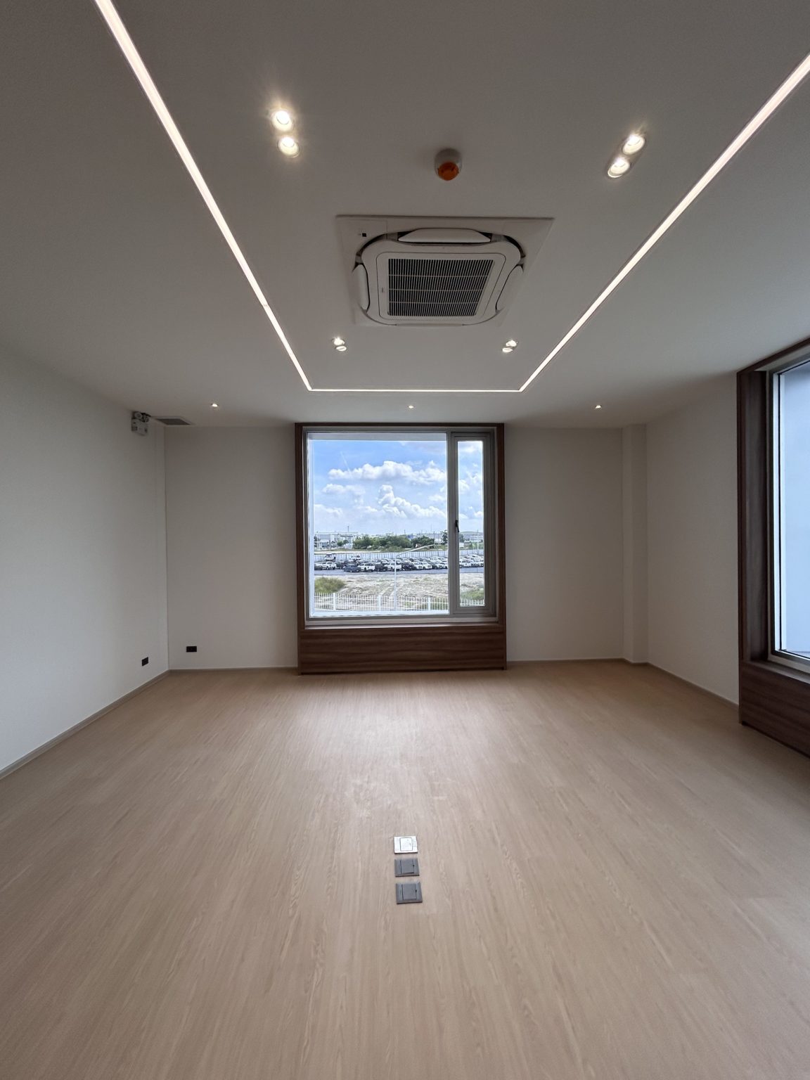 One large window with wooden frames in a bright office.