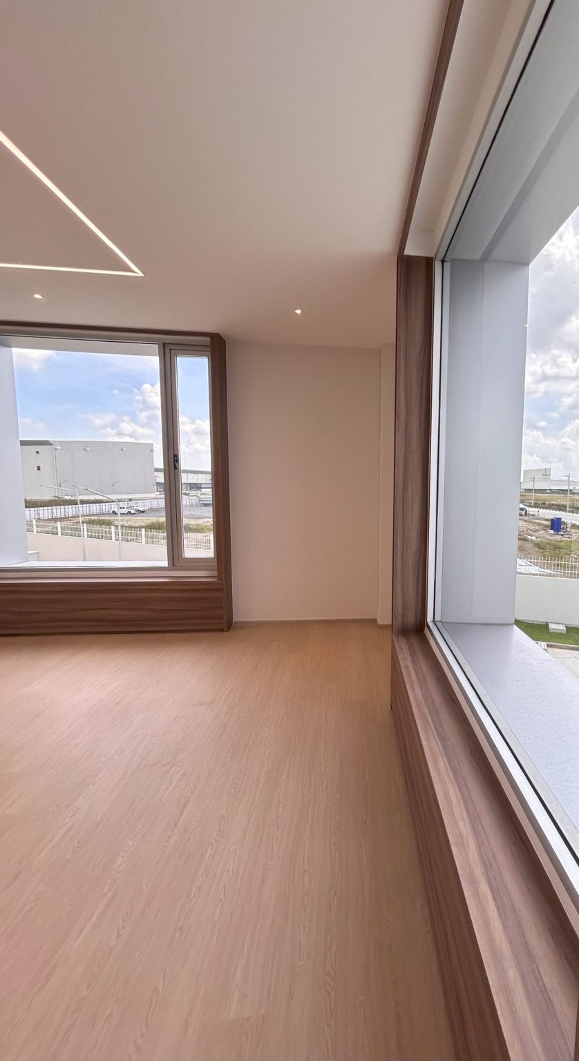 Office with large windows with wooden framework.