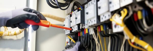 Electrician working in the electric panel.