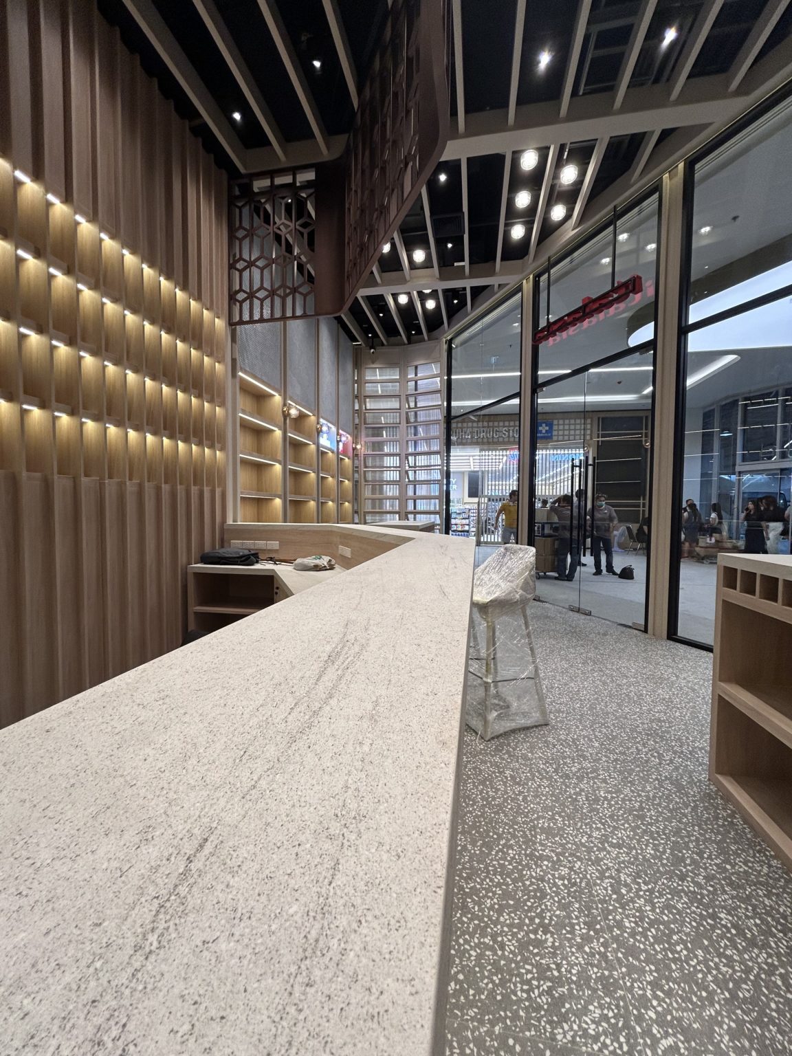 Interior Italasia, white large counter feartured with wooden shelves.