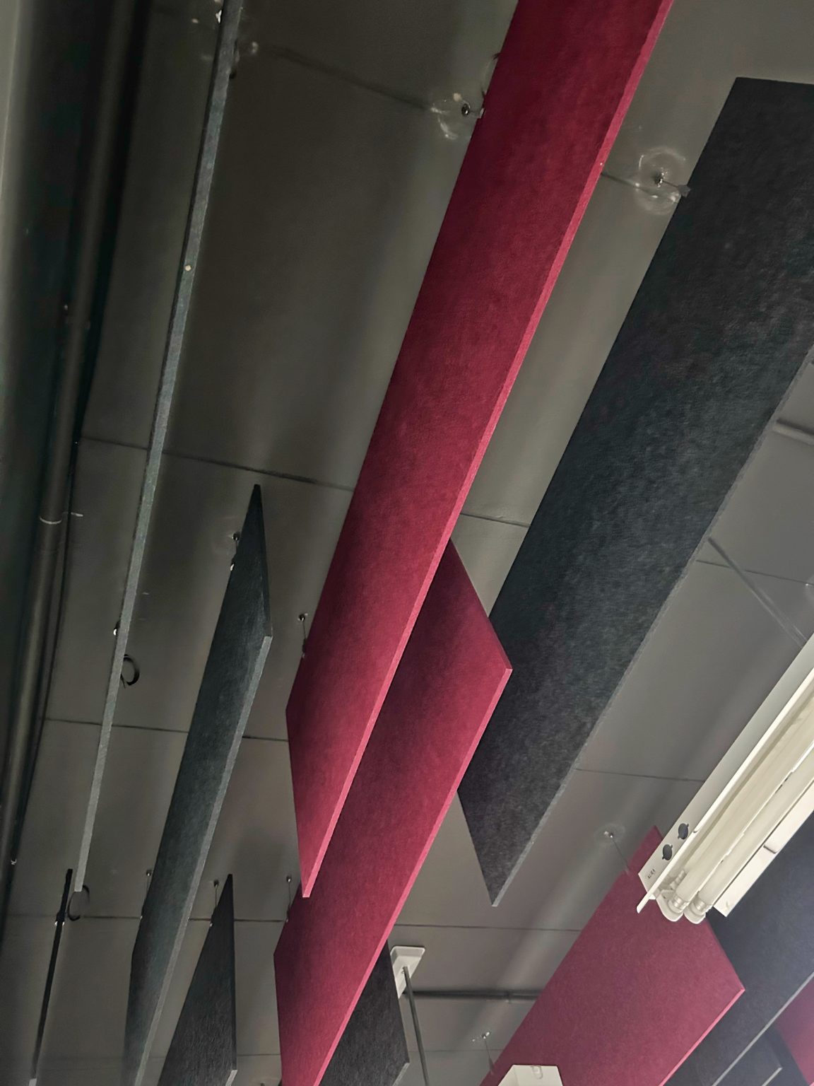 Red & black suspended acoustic panels installed by Project'Sabai.